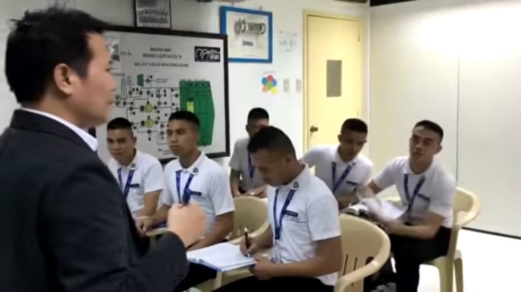 Maritime cadets listening to a discussion of their instructor.