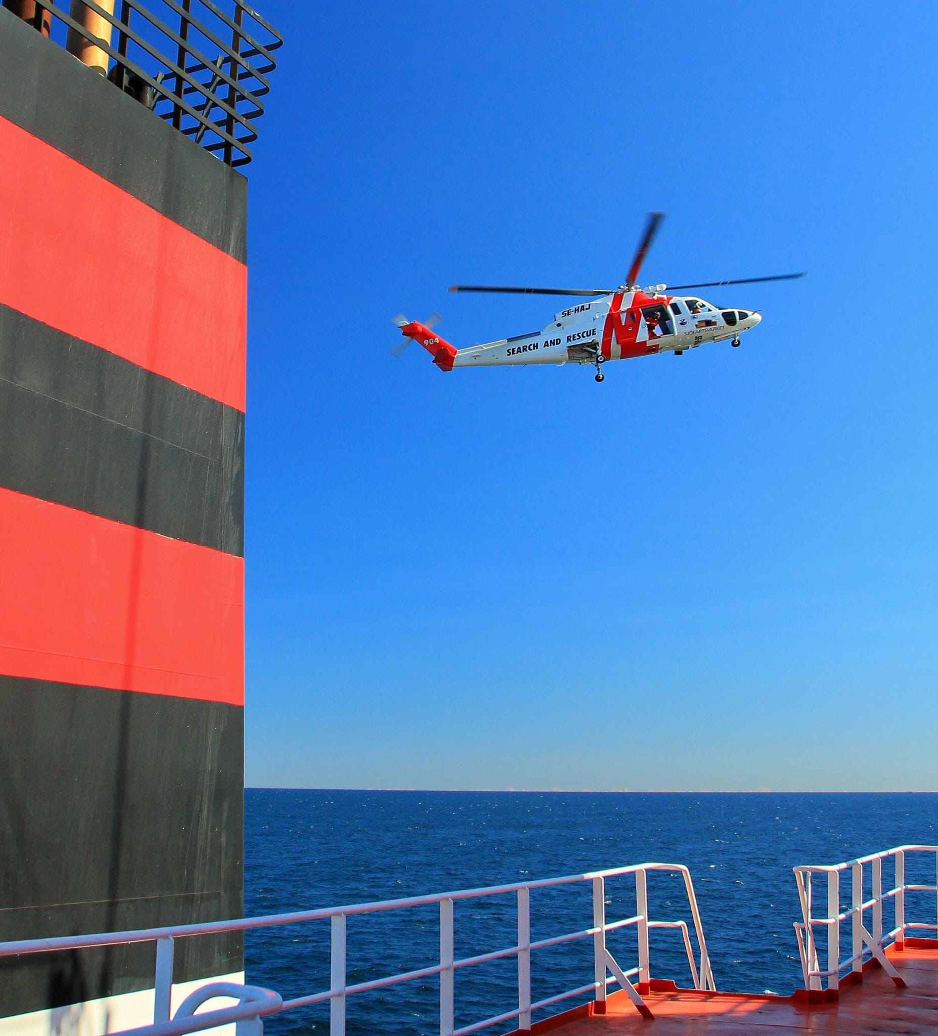 Search and Rescue (SAR) Helicopter approaching our bridge wing to send send their rescue officer down.