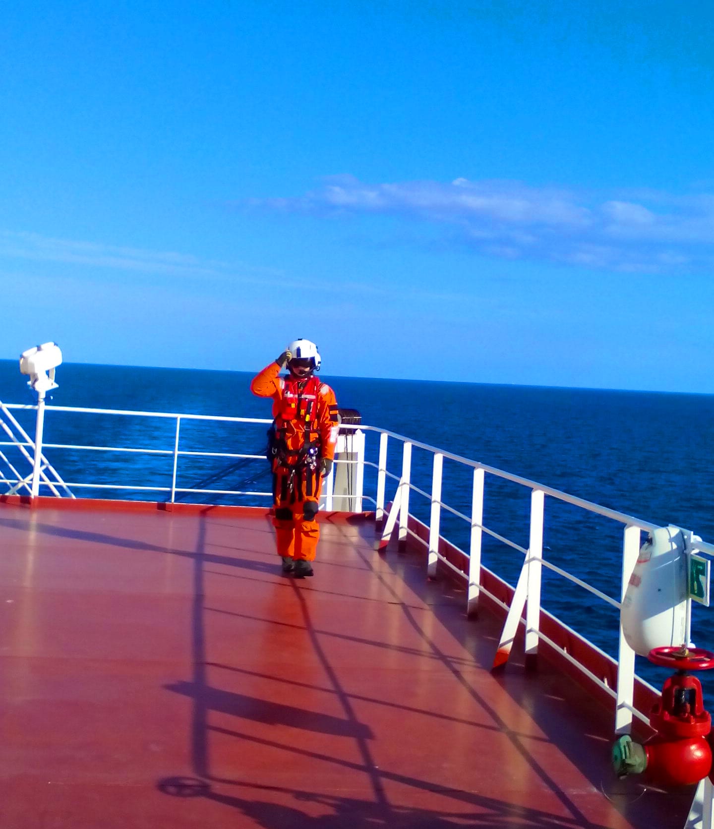 Swedish Search and Rescue Officer in full uniform walking towards the captain.