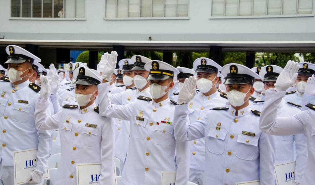 Fresh graduates from UC taking an oath during their graduation.