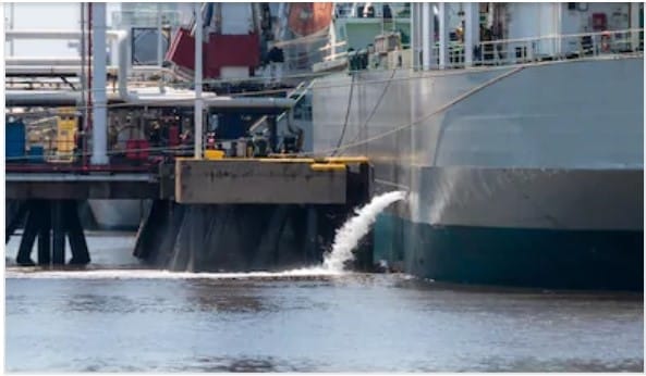A ship de-ballasting while alongside a terminal.