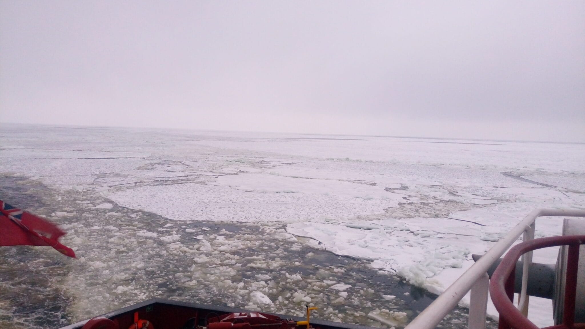 A vessel navigating on the waters that has turned into ice.