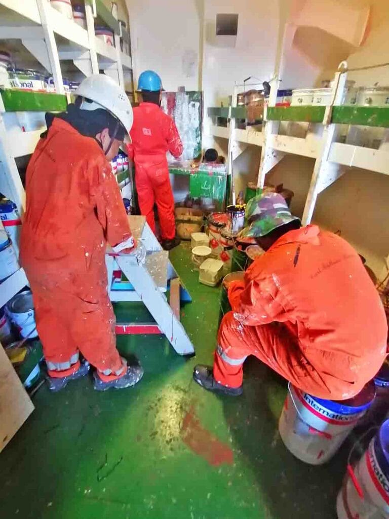 Deck crew inside the paint room preparing paint for their day job.