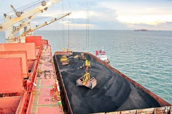 Geared bulk carrier Loading using her own crane while being in an STS operation with a barge..