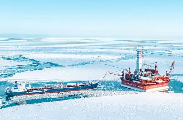 A shuttle tanker moored to an offshore oil platform with the surrounding seawater on ice.