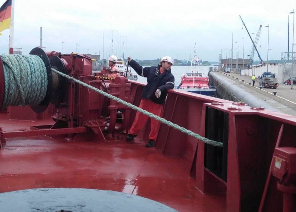 A crew driving the mooring winch as the ship fasts into the lock.