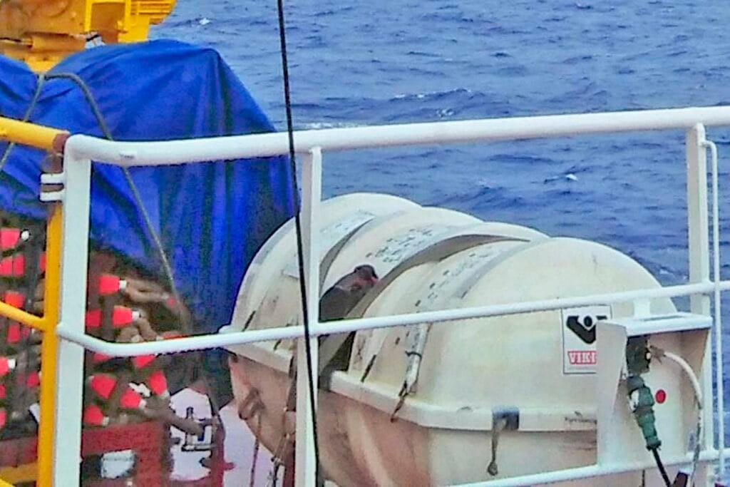 A liferaft beside the embarkation ladder ready to be deployed in times of emergency.