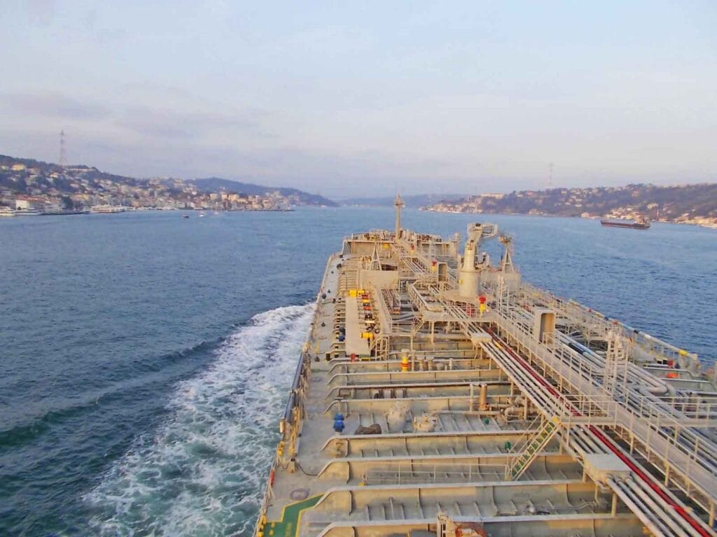 A tanker navigating safely along the middle of the channel.