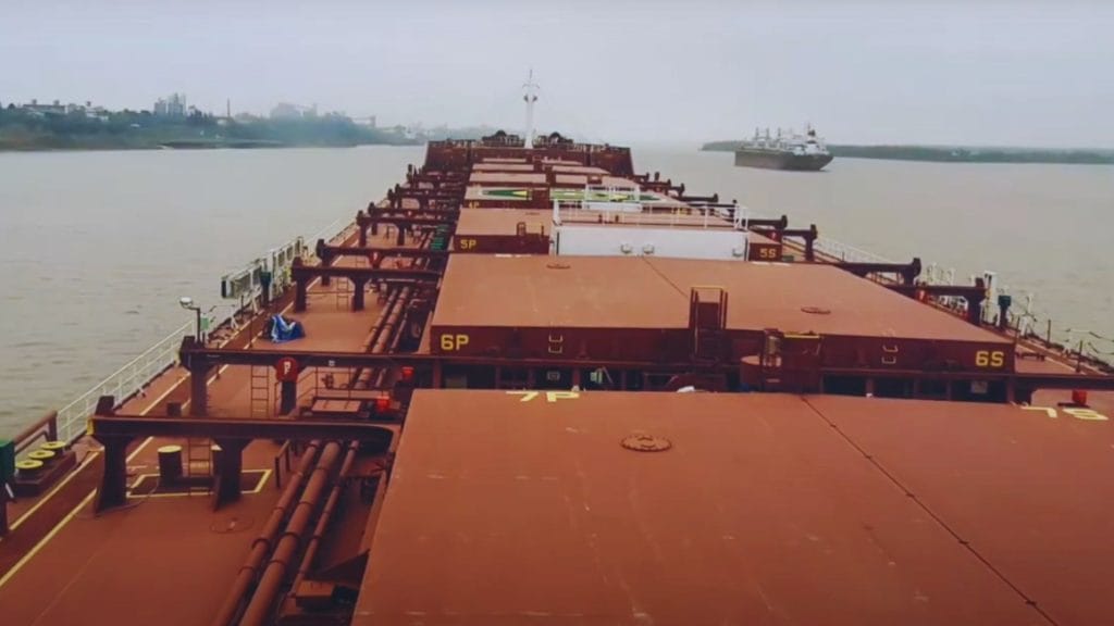 A ship navigating along a channel.