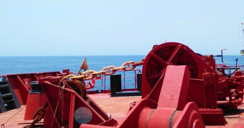 Portside anchor windlass and its fittings on the forward part of the vessel.