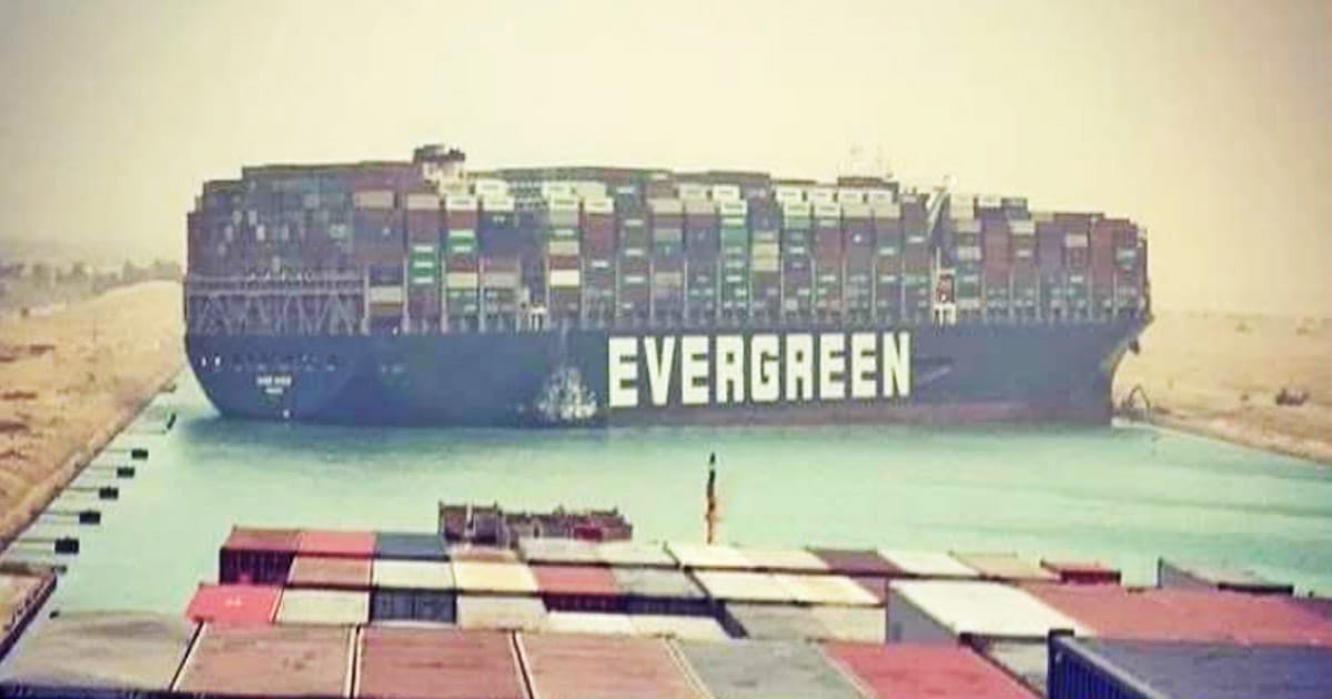 Close up view of M/V Ever Given blocking the Suez Canal showing her broadside in the middle of the canal.