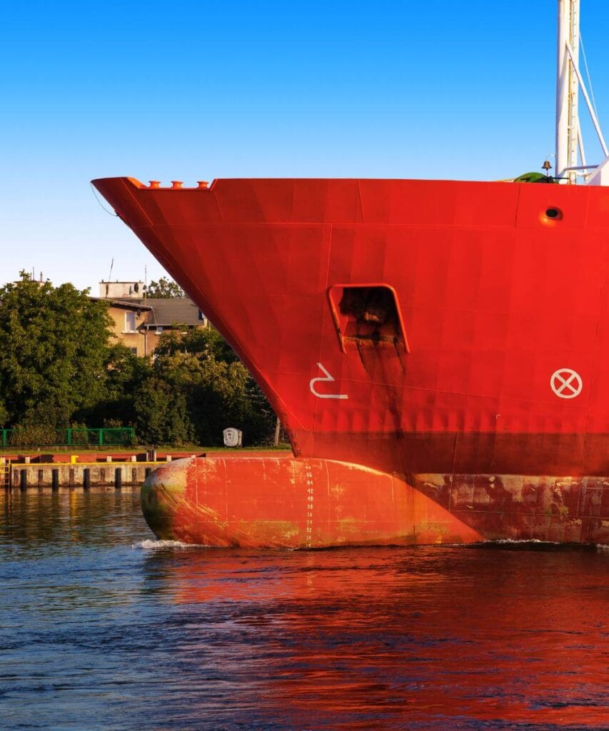 A ship with its bulbous bow visible above the water.